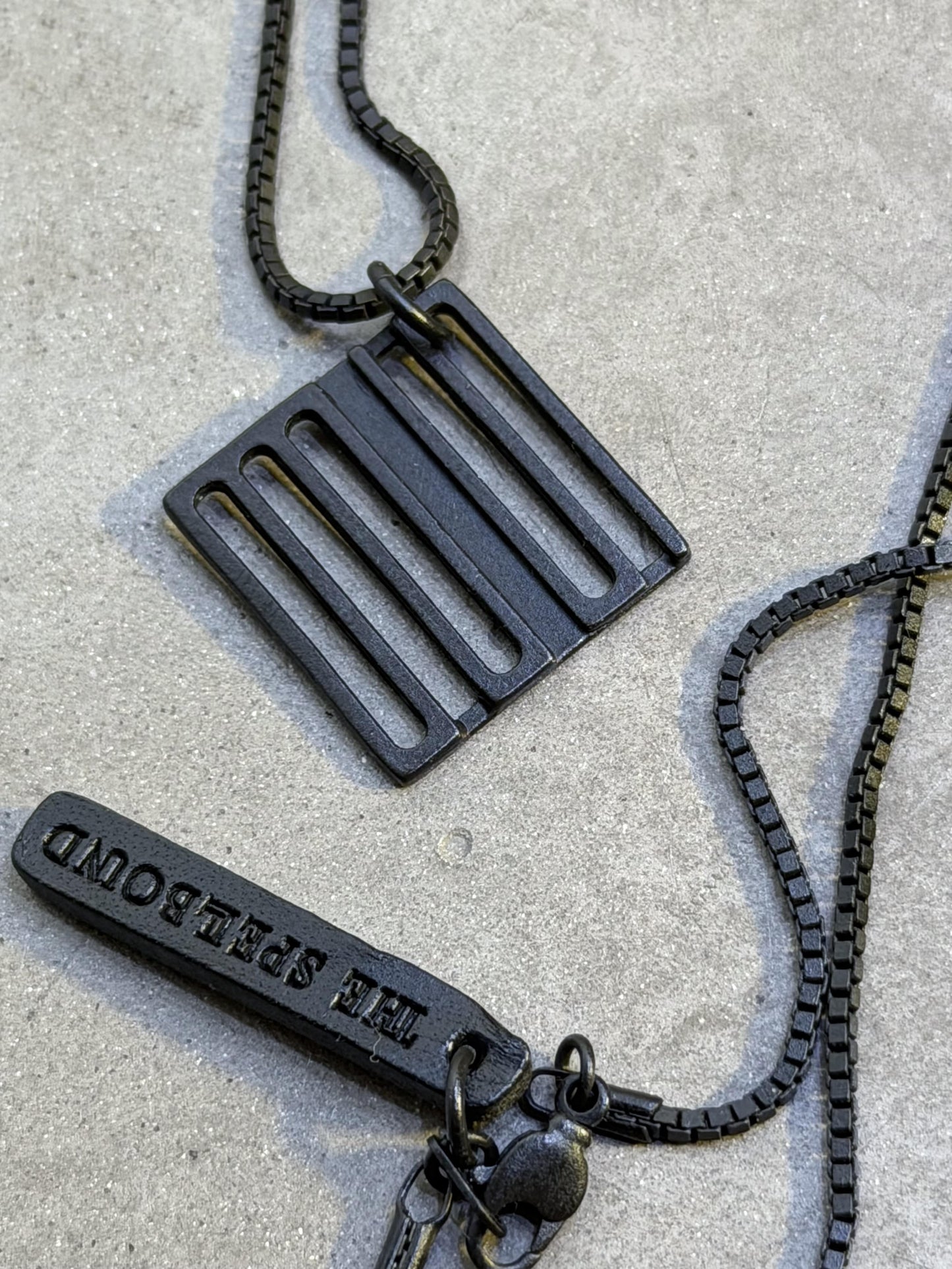 THE SPELLBOUND Metal Logo Necklace Black